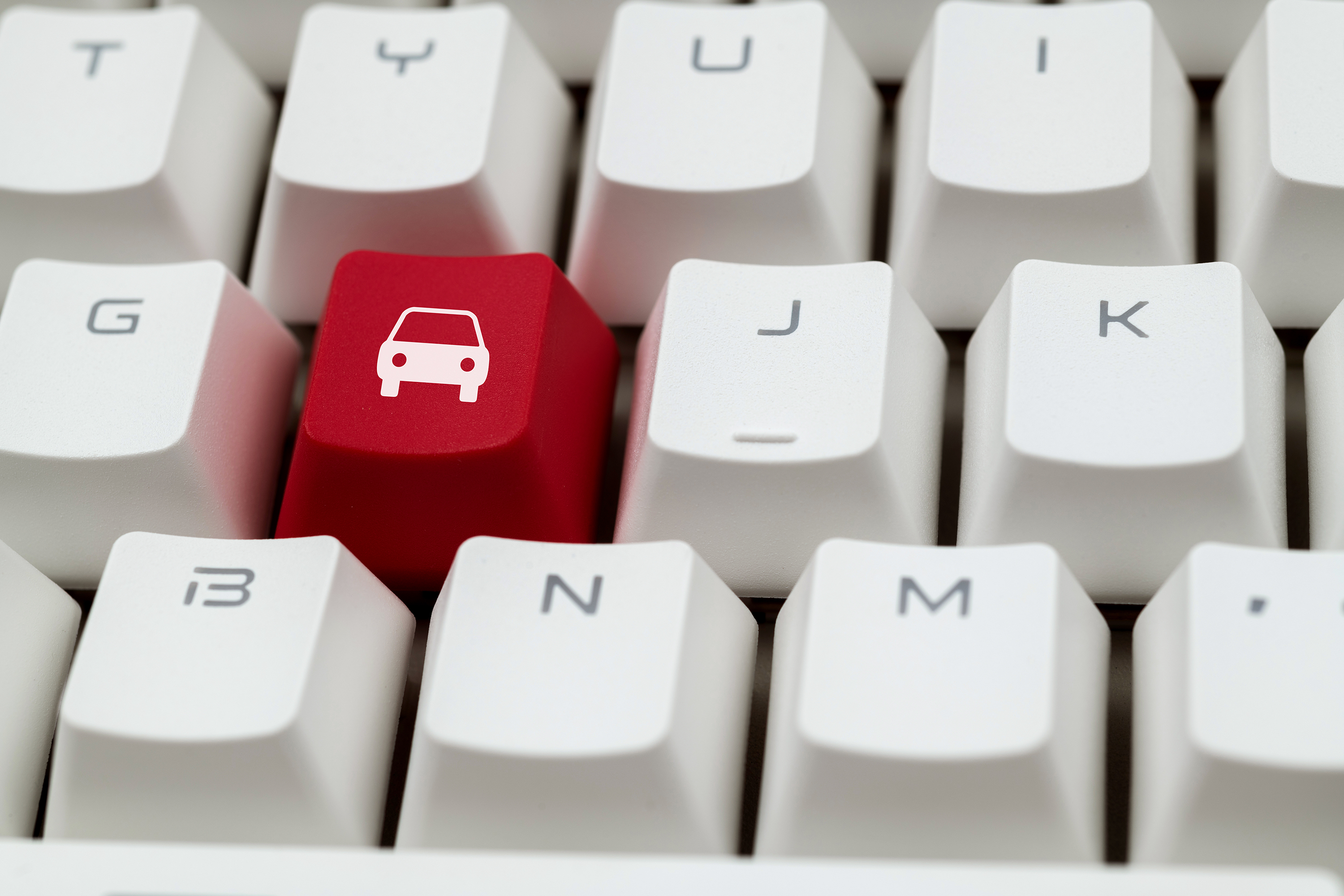 An image of a car icon on a keyboard.